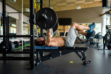 Fit man doing bench press exercises