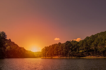 Landscape view of a lake in a tropical forest at sunset