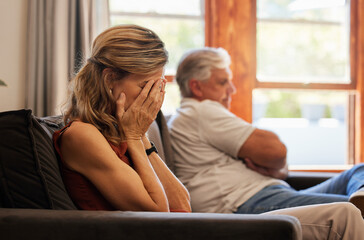 Crying, divorce and fight with a senior woman sad in her home after an argument with her husband. Depression, stress and couple with a wife angry after fighting with her elderly man sitting on a sofa