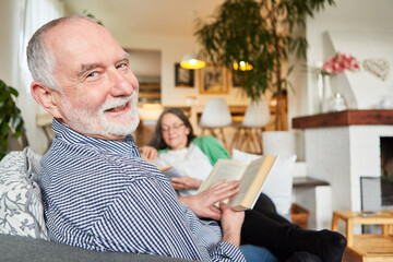 Happy retired senior reading a book