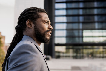 Profile view of elegant young adult african american businessman.