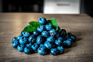 Heap of ripe blueberries with mint leaves