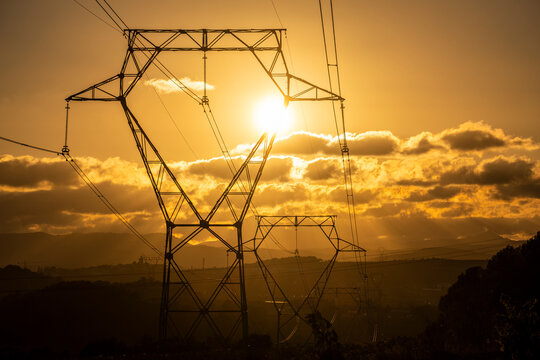 Towers of high voltage cables in an autumn sunset in the fields of the Penedes region in the province of Barcelona