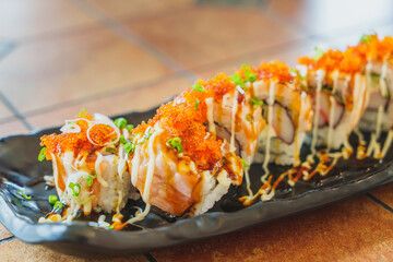 Japanese cuisine : Salmon sushi rolls with tobiko