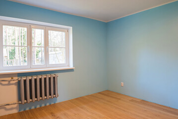 New home construction interior room with wooden floors and windows.