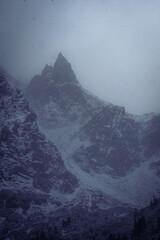 Snowy mountain peaks at Morskie Oko, Poland on a foggy, cold winter afternoon.