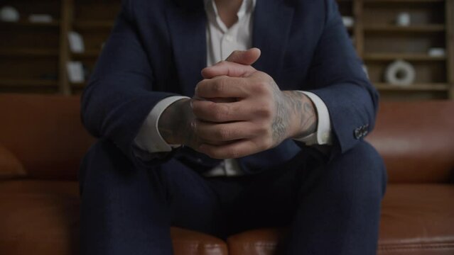 Tattooed Hands of a Businessman. Arms squashed close up.