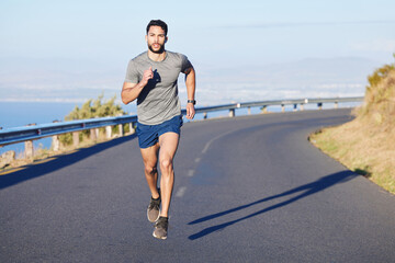 Fitness, man and running on a mountain road in South Africa for healthy cardio workout in the outdoors. Active athletic male runner in sports training having a run on the street in nature - obrazy, fototapety, plakaty