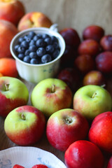Various healthy seasonal food arranged on wooden background. Selective focus.