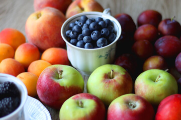 Various healthy seasonal food arranged on wooden background. Selective focus.
