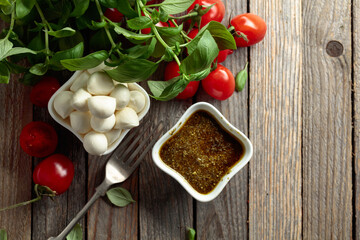 Mozzarella cheese with basil, pesto sauce, and tomatoes.