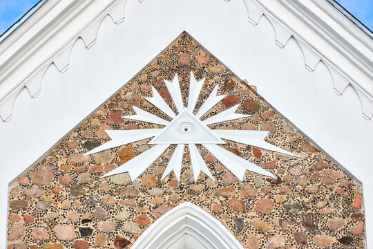 Gozha, Hoza - November 2021: All Seeing Eye symbol as detail of Catholic church of St. Peter and St. Paul decoration in Gozha, Hoza near Grodno Belarus. Masonic Triangle and eye Illuminati symbol.