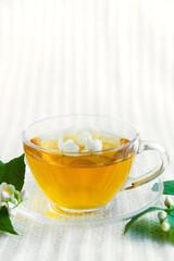 Jasmine herbal tea on a white knitted background. copy space	