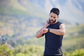 Man on run check pulse, heart rate and body stats for health with smartwatch on nature run. Runner does outdoor exercise for fitness, sports workout and cardio training to increase race running time