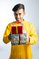 Fototapeta premium Man holding gift boxes during Diwali festival