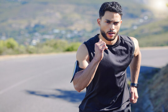 Training, Fitness And Man Running On Road With Endurance, Energy And Strength. Male Doing Workout, Run And Exercise For Marathon In The City. Motivation, Inspiration And Determination In Sports