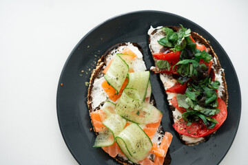 breakfast sandwich with tomato and toast with salmon