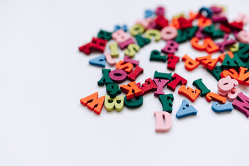 Colorful small scattered wooden letters	