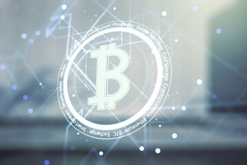 Double exposure of creative Bitcoin symbol hologram on modern business center exterior background. Cryptocurrency concept