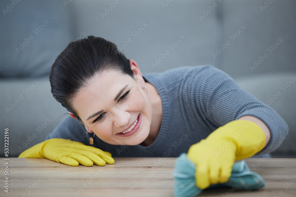 Poster Woman with gloves, cleaning the table in living room, hygiene and wipe stain on furniture. Wash, clean and girl doing domestic chores at home with cloth for dust, dirt and bacteria with rubber gloves