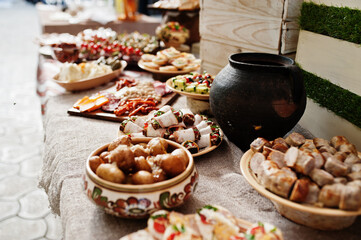 Buffet table of reception with cold snacks, meat and salads.