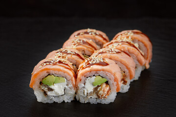 set of rolls on a round wooden board on a black background