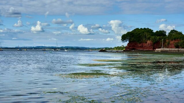 Lympstone in Devon on the Exe estuary. Timelapses of the red sandstone cliffs with the tide coming in. England UK