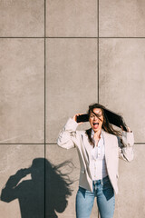 Young business woman screaming angry in frustration outdoor