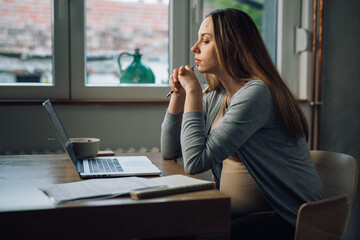 pregnant businesswoman working remote from home