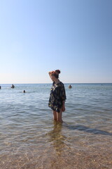 girl with red hair resting on the sea