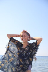 girl with red hair resting on the sea