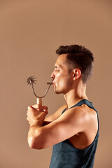 Young man testing breathing function by breath a cizer. Take care about health.