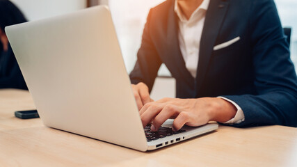 Closeup of businessman working at office, Man hands typing keyboard on laptop or computer.	
