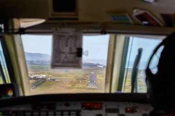 Controlling a small aircraft in the flight deck, view of the runway - 537228104