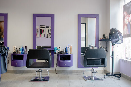 Back view of hairdressing chairs and mirrors.