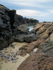 Beautiful shot of a sandy beach with rocks and cliffs in Harris, Outer Hebrides