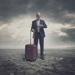 Businessman traveling in a barren land