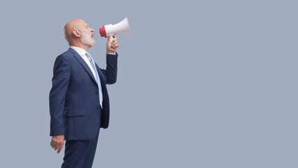 Businessman shouting a message using a megaphone