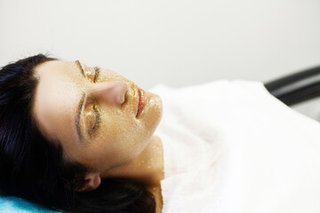 Obraz na płótnie Canvas Woman getting facial care in spa salon