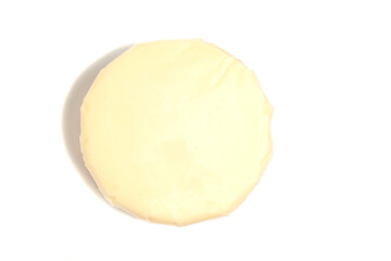 Suluguni cheese isolated on white top view