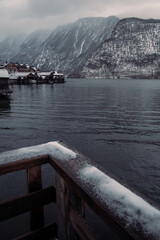 Typical alpine style buildings in Hallstatt, Austria during a snowy winter afternoon.