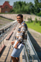 Young african american man with a laptop in the countryside