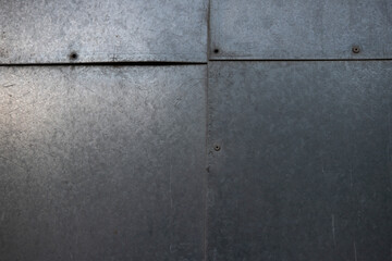 Plaques de métal, morceaux de fer fixés par des rivets. Image pouvant servir de texture ou d'arrière plan