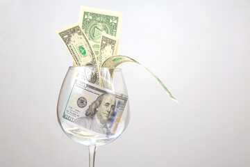 Fototapeta na wymiar dollar money in an empty wine glass. Online business sale. Financial success in the trading business.