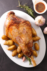 Roast leg of lamb with potatoes and sauce