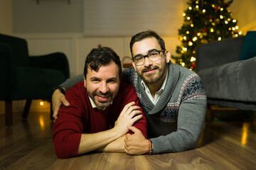 Smiling gay couple embracing looking relaxed on christmas