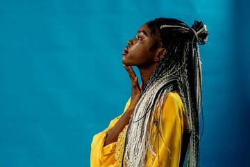 Fototapeta premium a girl in a yellow dress on a blue background