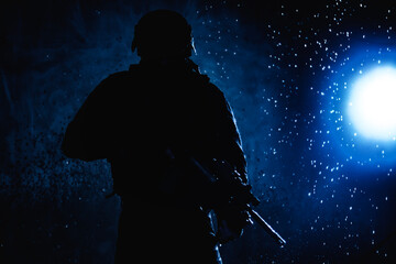 Special forces fighter, counter terrorist team shooter aiming assault rifle, shooting in firefight, breaking through rain on battlefield, rushing on enemies, attacking targets on moon night lit by