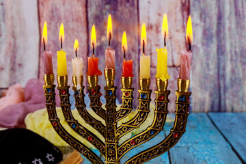 Jewish candlelighting in Menorah preparation for Hanukkah holiday with symbols festival