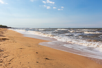 Fototapeta na wymiar The Black Sea in sunny weather. Surf on the beach, waves,sandy shore